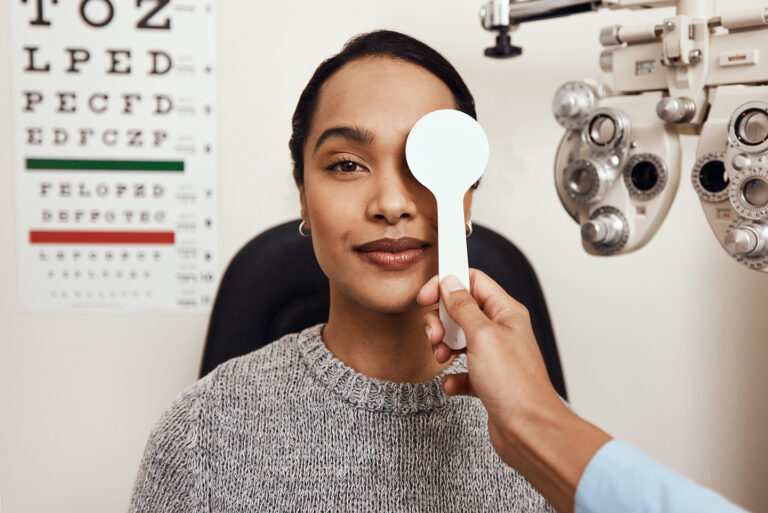 Smiling woman having her eyes tested for Astigmatism