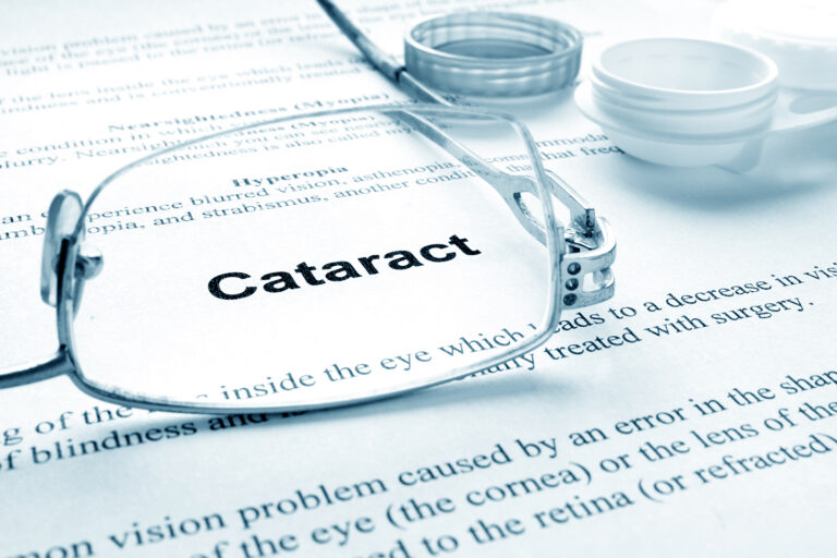 glasses placed on top of document that focuses on Cataracts