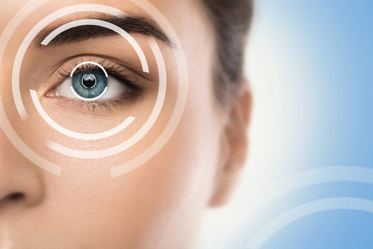 Close up of a woman with blue pupils being scanned for customised LASIK