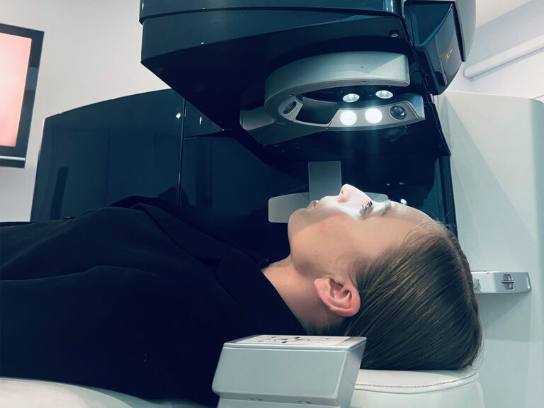 woman lying down in optometrist chair about to be examined for LASIK suitability