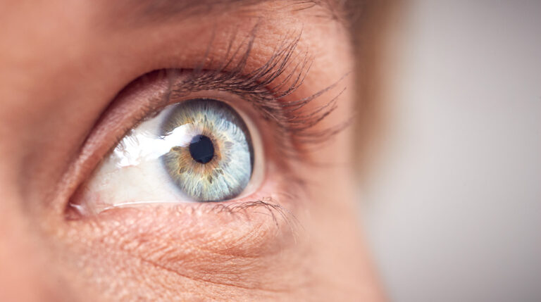 Close up of an eye with a blue-grey pupil